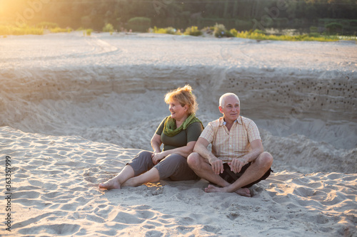 Happy elderly seniors couple in summer beach