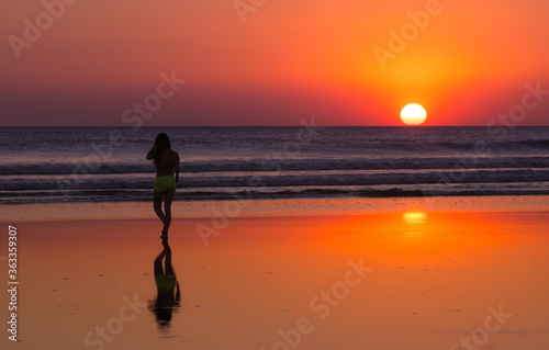 Girl walks alone on the beach
