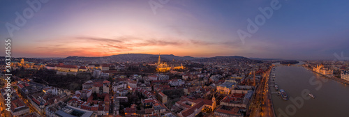 Panoramic aerial drone shot of lighted Matthias Church Buda castle on Buda Hill by Danube in Budapest sunset