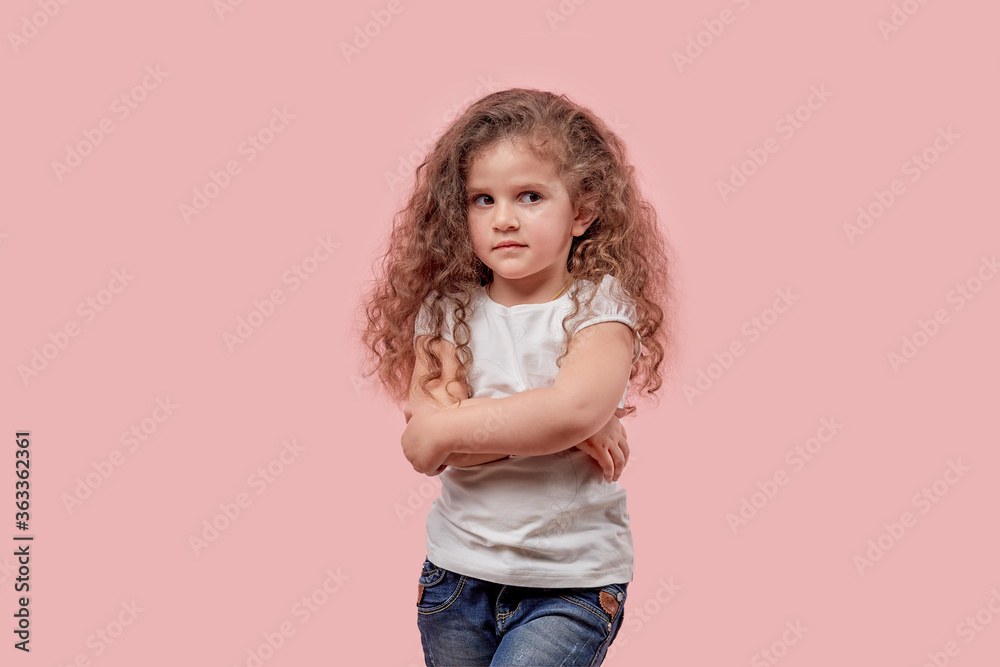 Beautiful girl with curly hair folded her hands together and looks away. Beautiful girl with curly hair folded her hands together and looks away.