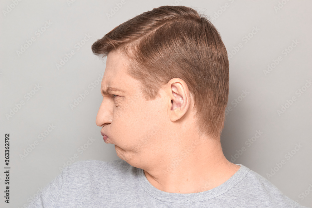 Portrait of funny goofy man puffing out his cheeks and pouting lips Portrait of funny goofy man puffing out his cheeks and pouting lips