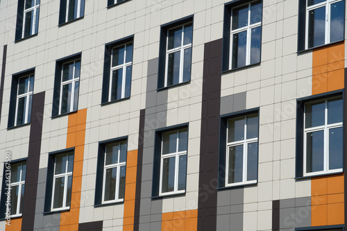 facade of a modern building on a bright Sunny day, siding and Windows, beautiful exterior of the new building © soleg