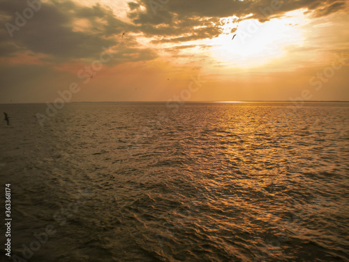 Beautiful sunset over sea with reflection in water  majestic clouds in the sky