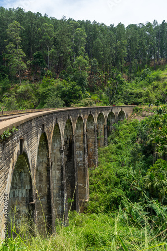 Nine arches Bridge in highlands near Ella, Sri Lanka. Jungle and tea plantation all around. Portrait format