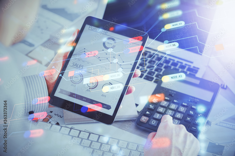 Double exposure of man's hand holding and using a digital device and data theme hologram drawing. Technology concept. Double exposure of man's hand holding and using a digital device and data theme hologram drawing. Technology concept.