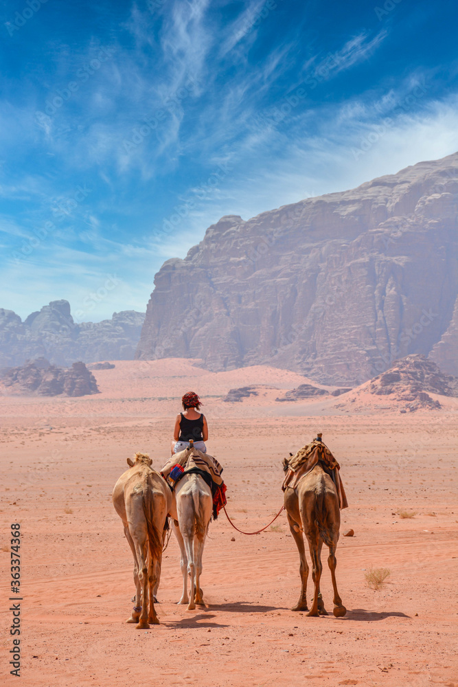 Female tourist riding a camel in the Wadi Rum desert
