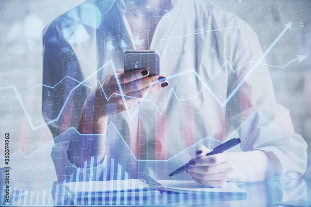 Double exposure of forex chart sketch hologram and woman holding and using a mobile device. Financial market concept. Double exposure of forex chart sketch hologram and woman holding and using a mobile device. Financial market concept.