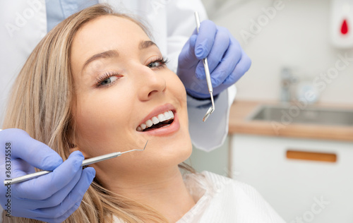 Fototapeta Naklejka Na Ścianę i Meble -  Woman having teeth examined at dentists