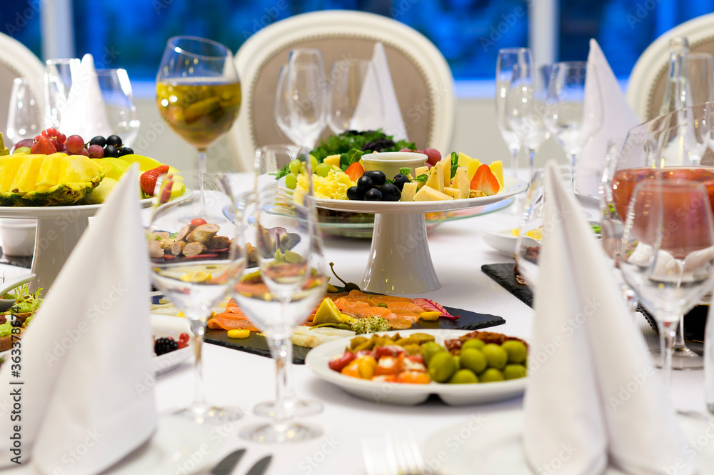 cheese plate with grapes on a table in a restaurant, cold snacks at a reception