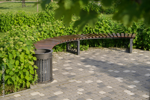 wooden seats in a landscape park surrounded by green spaces