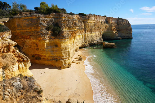 popular Marinha Beach beach with typical rock formations such as natural bridges and arches in the Algarve