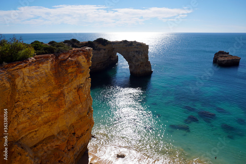 popular Marinha Beach beach with typical rock formations such as natural bridges and arches in the Algarve