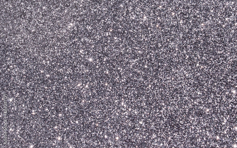 Silver, gray and black abstract glitter background with rough grain and shiny shimmering light reflections. Image is blank with room for text. Great for backdrop, textile, poster, textures, banners. Silver, gray and black abstract glitter background with rough grain and shiny shimmering light reflections. Image is blank with room for text. Great for backdrop, textile, poster, textures, banners.
