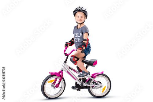 Little girl on a silver pink baby bike