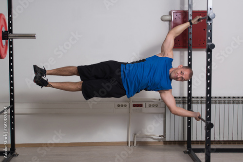 Muscular Man Doing Human Flag Exercise