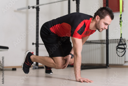 Young Attractive Man Training With Trx Fitness Straps