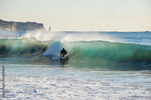 Photography Surfer on Blue Ocean Wave riding on surfing board in Asia