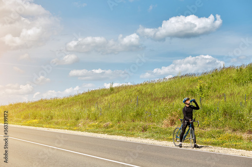 Professional cyclist rides on an empty highway view from above. A view of a bicyclist riding a bike