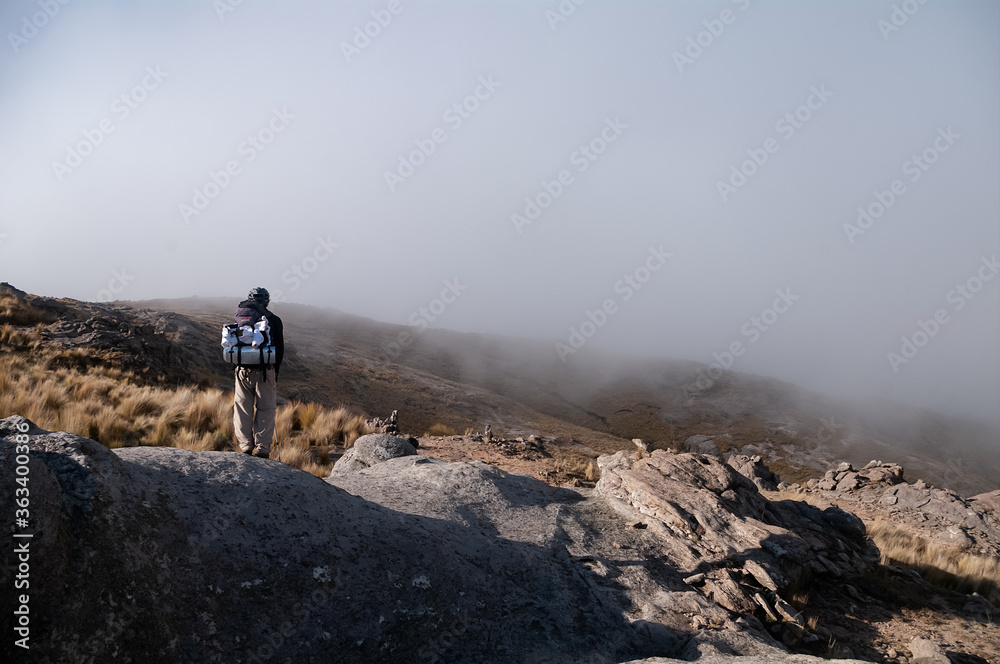 Man looking in the middle of the mountain