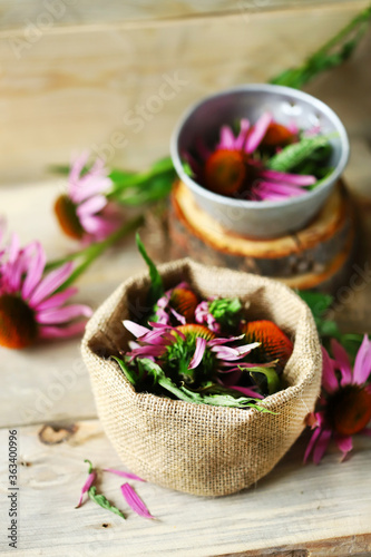 Selective focus. Echinacea flowers in a bowl and in the bag. Harvesting Echinacea. Plant for immunity