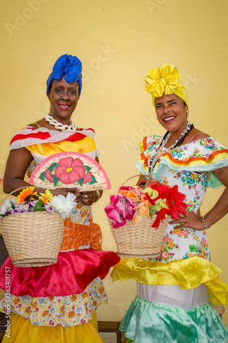 Two colorful Cuban ladies in traditional costumes © Jo