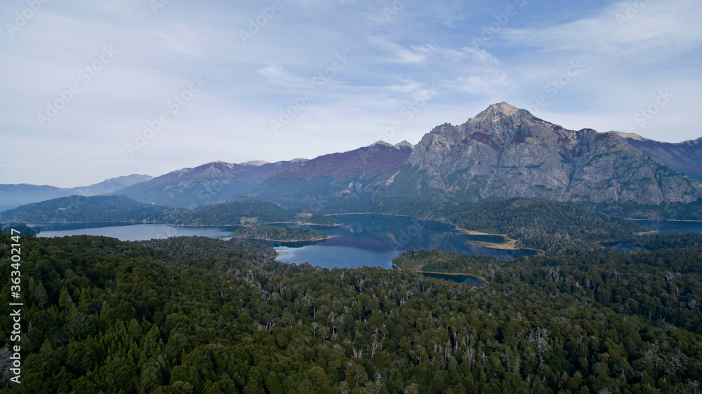 Woods landscape. Aerial view of the forest, lakes and mountain with a rocky peak.