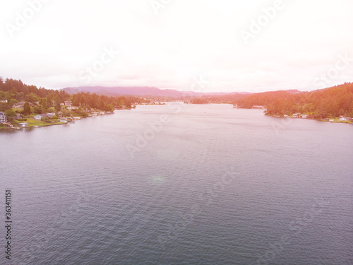 River with forests about the town on a sunset background top view