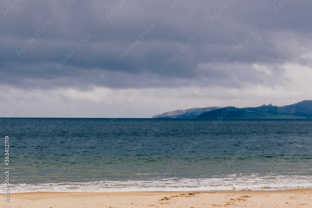 beautiful Tasmanian beach landscape with stormy sky