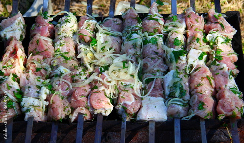 Cooking juicy meat in the summer on a picnic in the coals on the grill and skewer