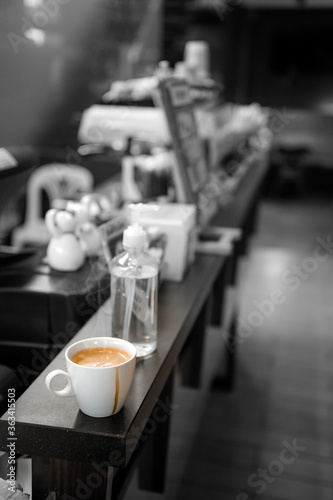 black coffee in white cup put on coffee maker