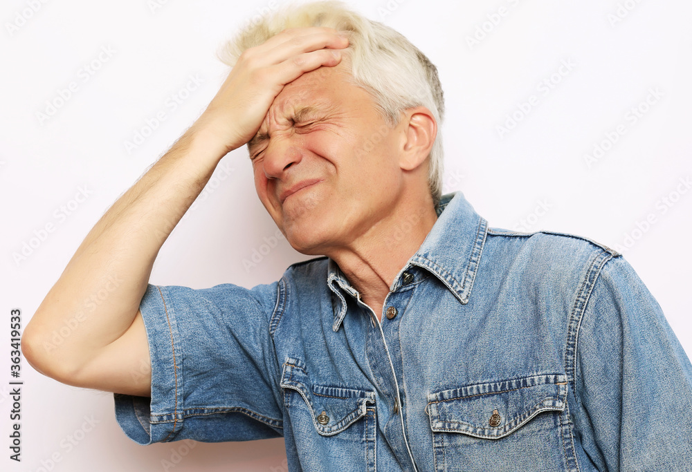 lifestyle, health and people concept: Senior man has headache, on white background lifestyle, health and people concept: Senior man has headache, on white background