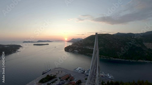 Aerial Drone Footage of Sunrise Across the Franjo Tudjman Bridge in Luka Gruz, Croatia.