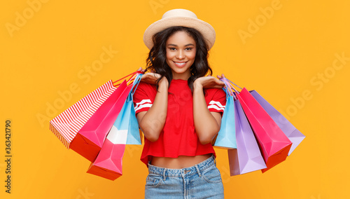 Stylish ethnic woman with shopping bags. photo