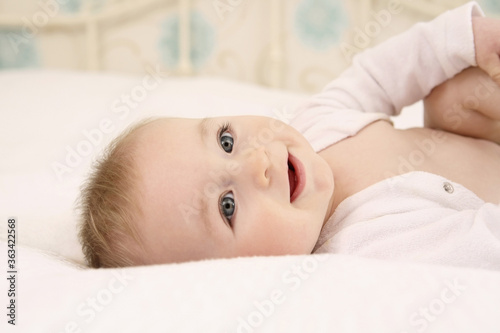 Baby boy lying down on bed