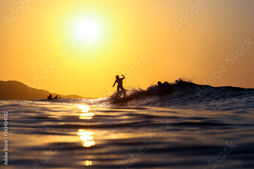 Surfing at sunrise & sunset in Japan Silhouettes of the Surfers taken while swimming in the Pacific Ocean. 