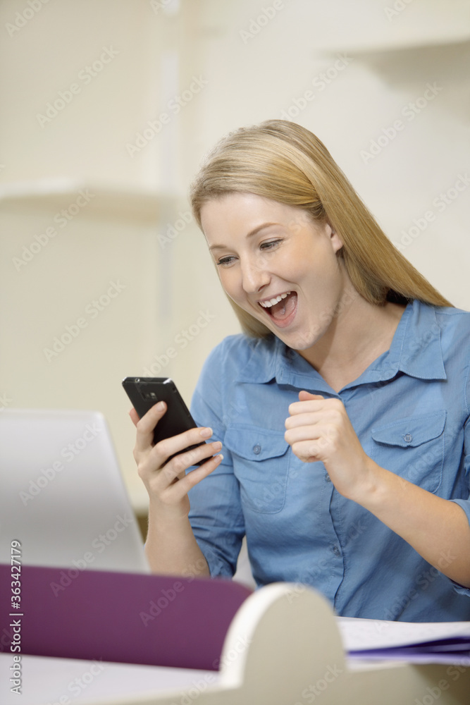 Businesswoman reading text message on smart phone Businesswoman reading text message on smart phone