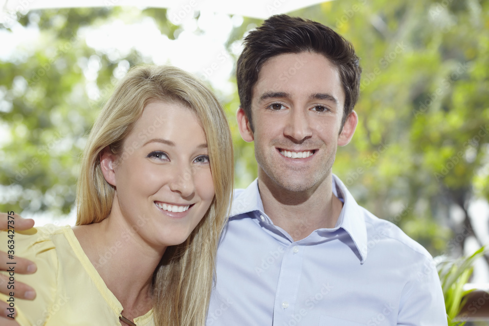 Man and woman standing together, with arms around Man and woman standing together, with arms around