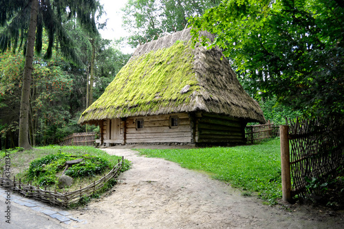 Traditional ukrainian old house in the contry, old farmhouse with a thatched roof.