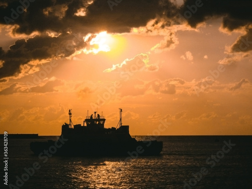cargo ship in the sea at sunset 