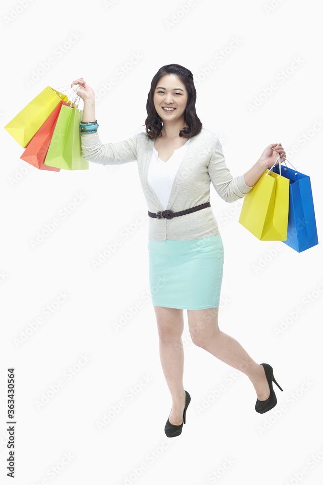 Cheerful woman carrying paper bags Cheerful woman carrying paper bags