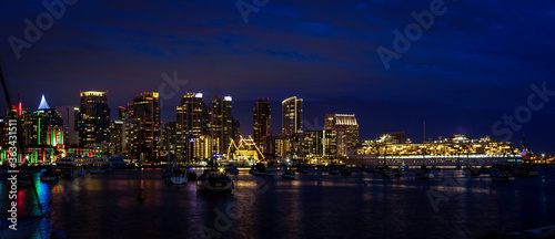 Sunset and night view of San Diego downtown with Christmas lights photo