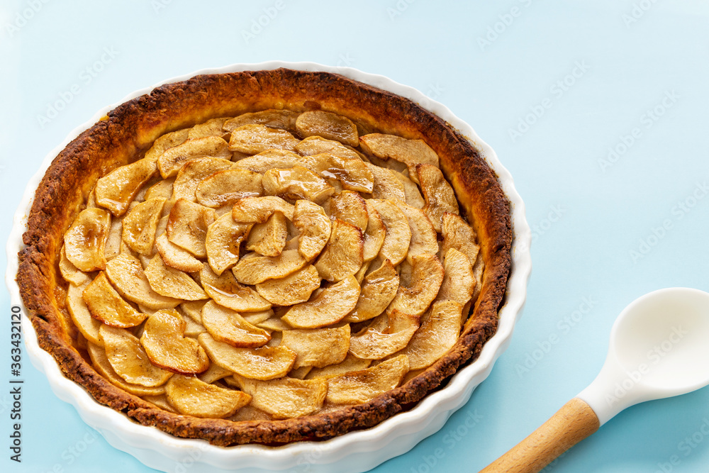 Homemade baked French apple tart, an open faced apple pie, in a baking