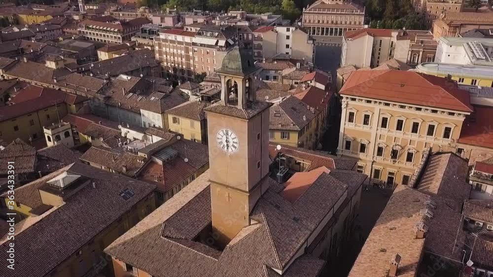 A clock tower in the center of an Italian city. A clock tower in the center of an Italian city.