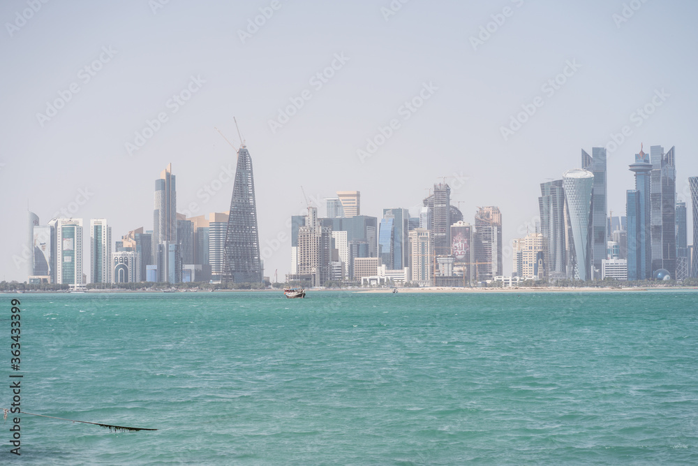 Scenic landscape from the Corniche in Doha with view of the sea and skyscrapers in Doha downtown cityscape