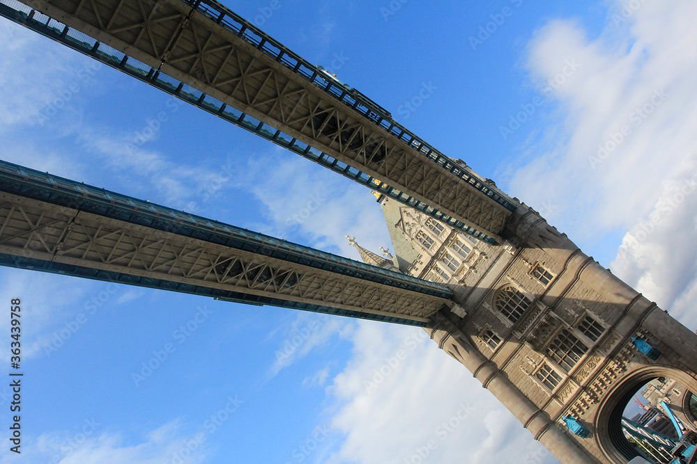 A view of the drawbridge of Tower Bridge , London from River Thames against clear blue skies