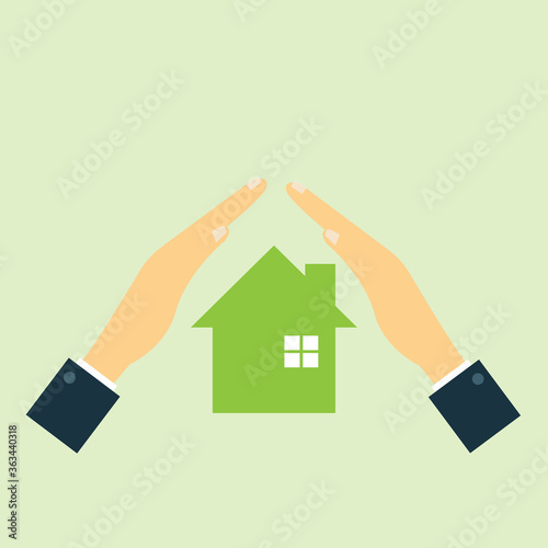 Hands protecting Warm and cozy miniature a small model of a house.