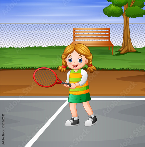 Happy girl playing tennis at the courts