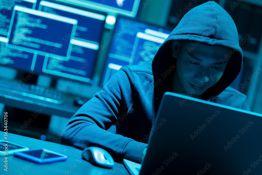 Asian male hacker use laptop Asian male hacker use laptop
