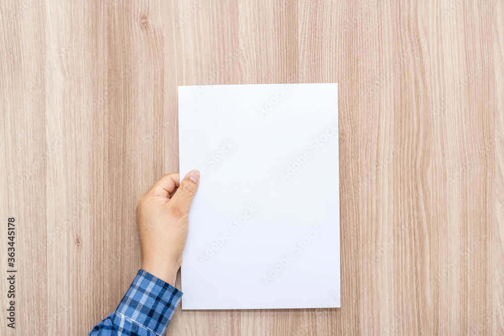 Fototapeta premium Person holding white empty paper