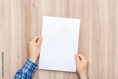 Person holding white empty paper